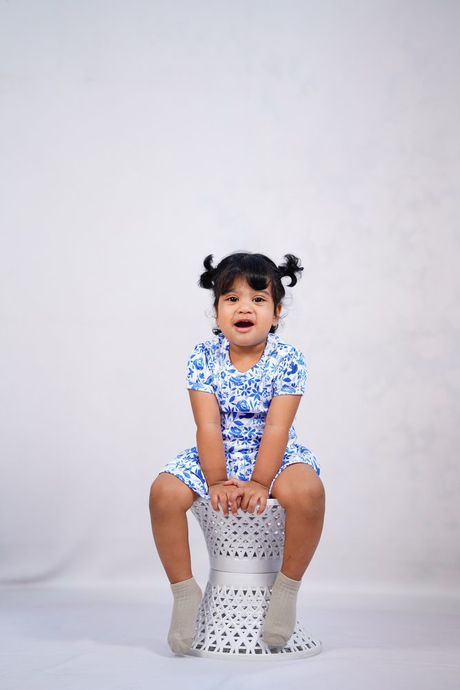 A child in Pangea & Co.'s blue Birdsong dress set from the Neelam collection