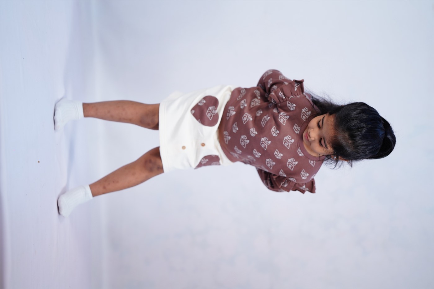 A rail of earthy-toned pieces from the Echoes of Kolam collection