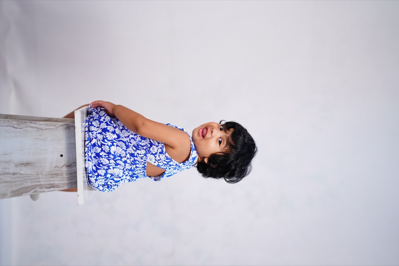 A child in Pangea & Co.'s blue Birdsong dress set from the Neelam collection