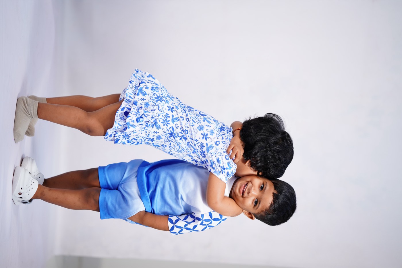 A child in Pangea & Co.'s blue Birdsong dress set from the Neelam collection