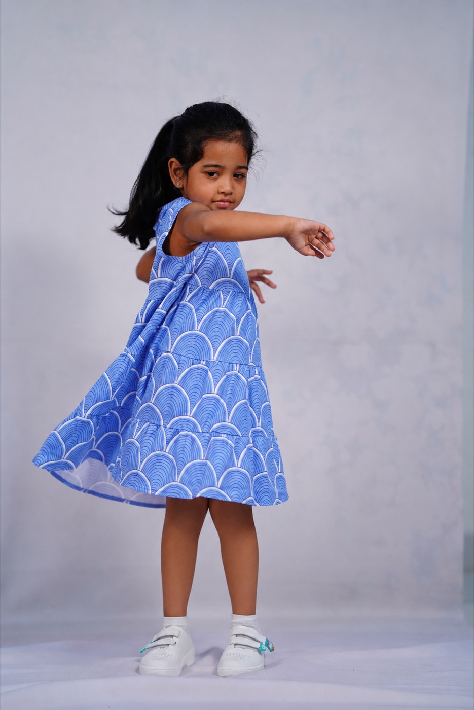 A child in Pangea & Co.'s blue Birdsong dress set from the Neelam collection