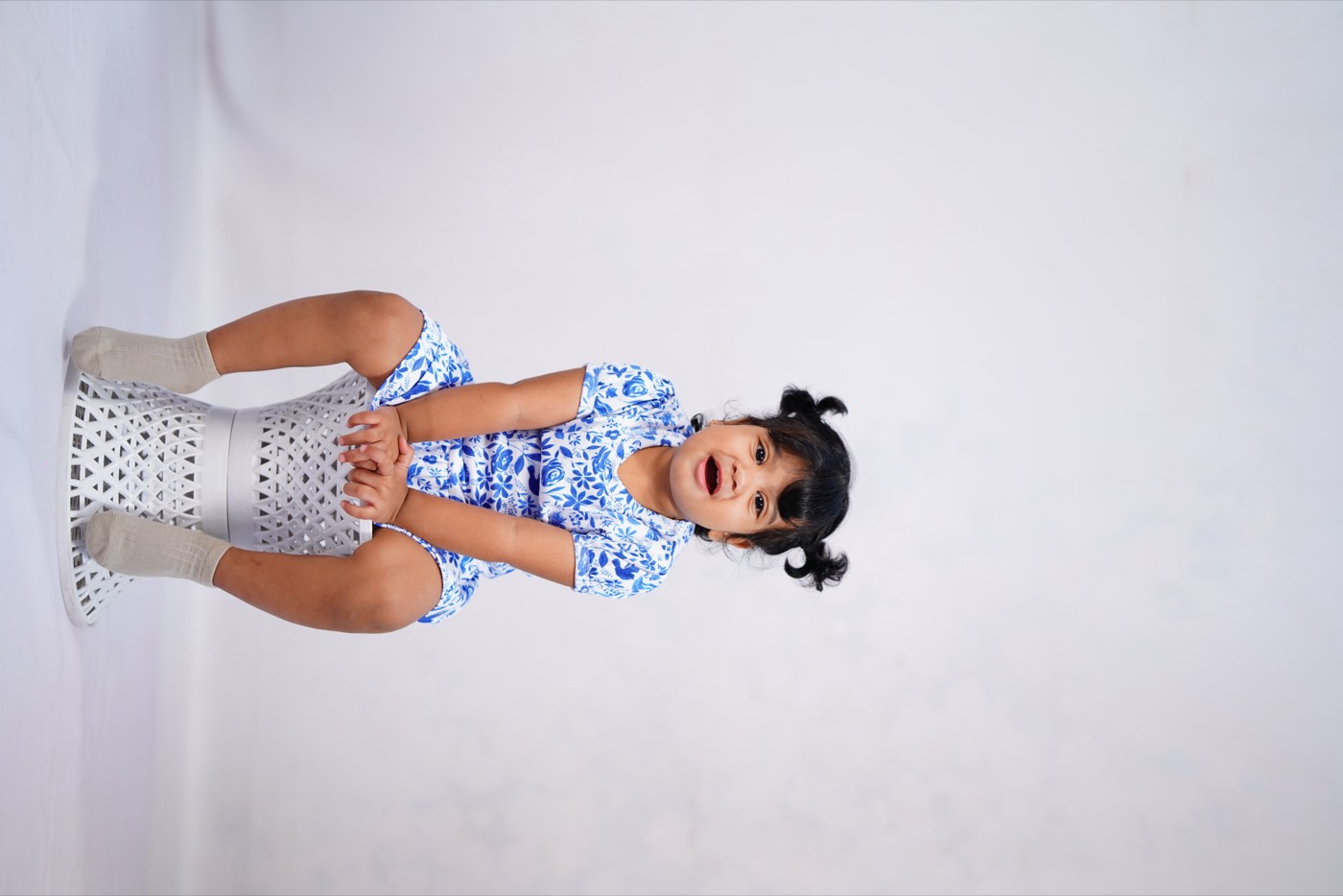 A child in Pangea & Co.'s blue Birdsong dress set from the Neelam collection