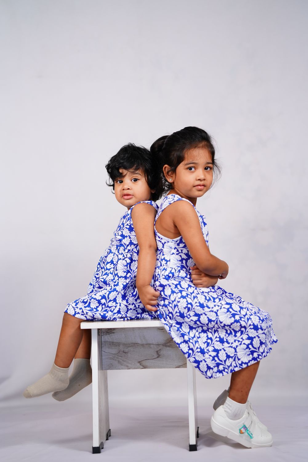 Two children together in Pangea & Co. organic cotton dresses